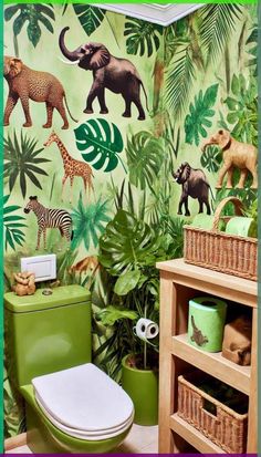 a green toilet sitting next to a wall with jungle animals on it's walls