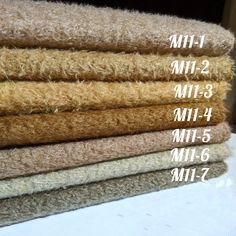 four different types of carpet stacked on top of each other