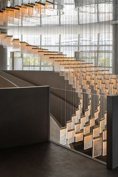 the interior of a building with many lights hanging from it's ceiling and stairs