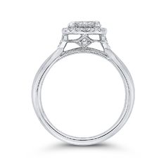 a white gold engagement ring with two diamonds on the shoulders and an oval halo setting