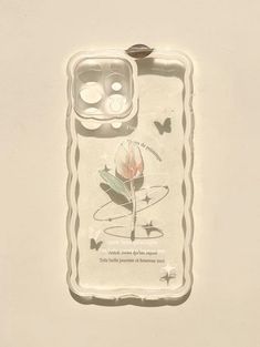 a cell phone case with a flower and butterflies on the back, attached to a wall