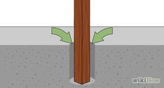 a wooden pole with two arrows pointing to the ground and one arrow pointing towards the ground