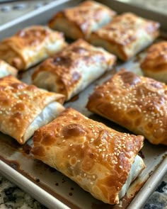 several pastries are sitting on a baking sheet