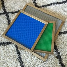 two legos sitting on the floor next to each other in front of a rug