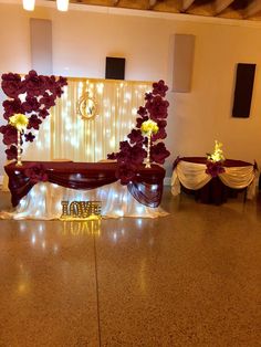 a room filled with tables and chairs covered in purple flowers