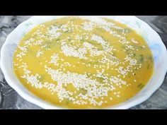 a white bowl filled with soup on top of a table