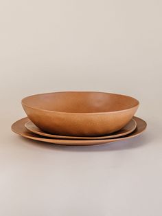 two brown plates sitting on top of each other