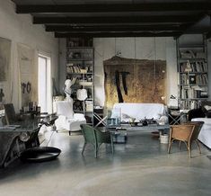 a living room filled with furniture and bookshelves