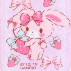 a pink towel with an image of a little bunny holding a gift box and bows