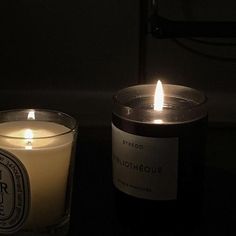 two candles sitting next to each other on a table