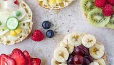 fruit tarts with kiwis, raspberries, and bananas on them