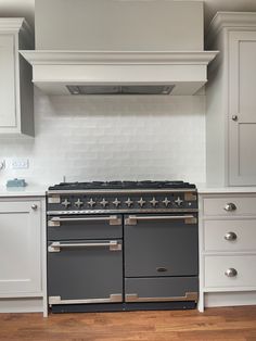 French style range cooker with white matt tile backsplash Belling Farmhouse Range Cooker, Rangemaster Elise 110, White Range Cooker Kitchen, Rangemaster Elise 110 In Kitchen, Hidden Cooker Hood, Range Cooker Hood, Cooker Backsplash Ideas, Shaker Kitchen With Range Cooker