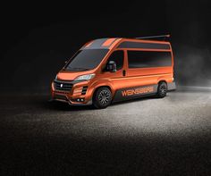 an orange van is parked in the dark