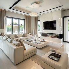 a living room with white furniture and large windows