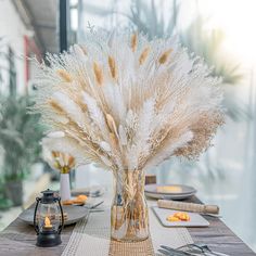 there is a vase with feathers on the table