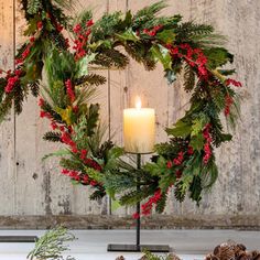 a candle is lit in front of a wreath