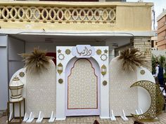 an elaborately decorated entrance to a building in the middle of a courtyard with chairs and tables