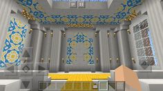 the interior of a building with blue and yellow designs on it's walls, windows, and ceiling tiles