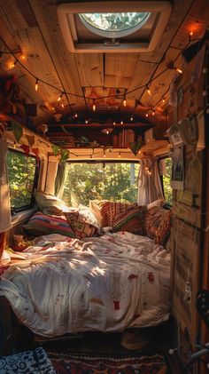 a camper van is decorated with lights and pillows