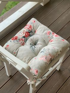 a white chair sitting on top of a wooden deck