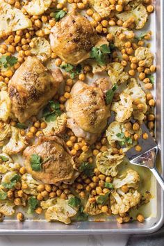 chicken and chickpeas in a casserole dish with garnishes