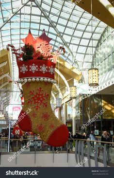 christmas stockings hanging from the ceiling in an indoor shopping mall