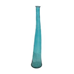 a tall blue glass vase sitting on top of a table