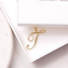 T Initial Necklace - Cursive "T" initial - Gold necklace for women - Gold chain - Classic gold necklace - Gold jewelry for her, for mom Dainty "T" initial. Perfect every day necklace. Lovely gift for your self, sister, bridesmaids, new mom. Pendant: Base metal is brass and 14K gold plated. Chain is 18 inches, 14k gold filled. Note: model shots might show a different initial, only to illustrate overall look and length of the chain. This listing is for the "T" initial. T Initial Necklace, Friend Letters, Love Cursive, Initial Gold Necklace, Cursive T, T Initial, Gold Necklace For Women, Special Gifts For Her, Initial Necklace Gold