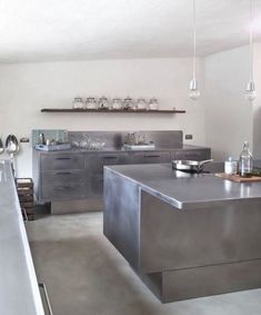 an industrial style kitchen with stainless steel counter tops