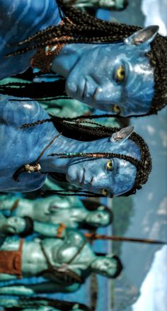 two blue statues with braids on their heads