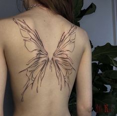 the back of a woman's body with a butterfly tattoo on her left side