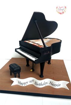 a birthday cake made to look like a piano and foot stool with a ribbon around it