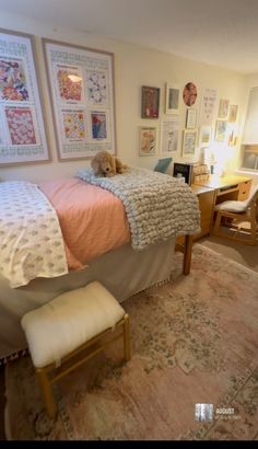 a bedroom with a bed, desk and pictures on the wall