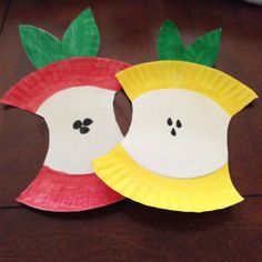 two paper plates with faces made to look like apples