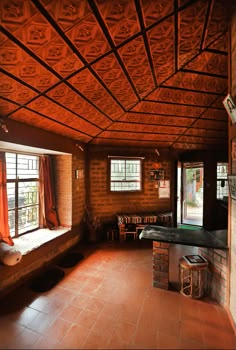 an empty room with wood paneling and tile floors