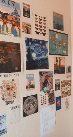 a wall covered in pictures and magnets next to a door