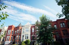 row houses with trees and bushes in the foreground