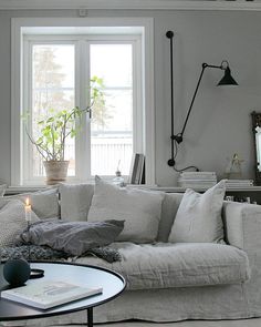 a living room filled with furniture and a large window