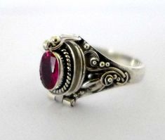 "This intricate .925 Sterling Silver Poison Ring. You can open it and store your favor treasures. The stone set on this ring is synthetic ruby. Ring size various and stone color is limited. Please use pull down menu to select. Dimension of the outer oval locket face: 12mm x 8mm Dimension of the inner locket space: 8mm x 6mm (similar size to a piece of rice) \"925\" is stamped on the back of the inner ring. All items are lead and nickel free, they are sterling silver, not silver plated or silver Poison Ring, Locket Ring, Compass Pendant, Sterling Silver Locket, Solitaire Rings, Oval Locket, Silver Locket, July Birthday, Silver Lockets