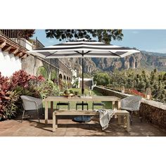 an outdoor table and chairs with an umbrella