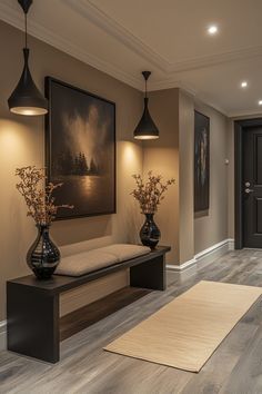 a hallway with two black vases and a white rug