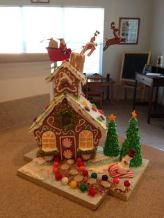 a gingerbread house is decorated with christmas decorations