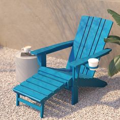 a blue adirondack chair with a cup on it