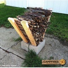 a pile of wood sitting on top of a cement block