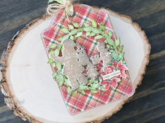 a christmas ornament is sitting on top of a piece of wood that has been cut into pieces