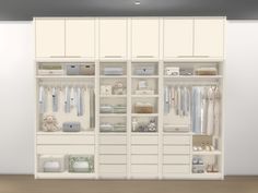 a white closet filled with lots of clothes