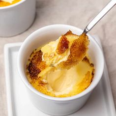 a white bowl filled with food on top of a table