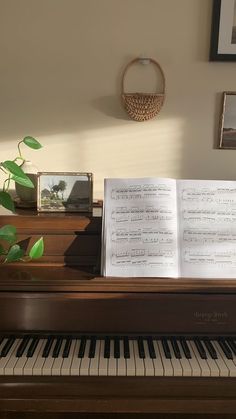 an open book sitting on top of a piano