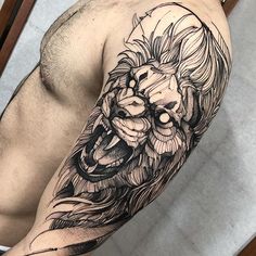 a man with a lion tattoo on his arm