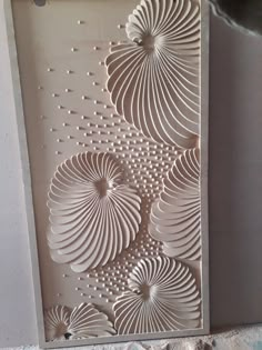 an intricately designed wall panel in the shape of flowers, with holes cut into it